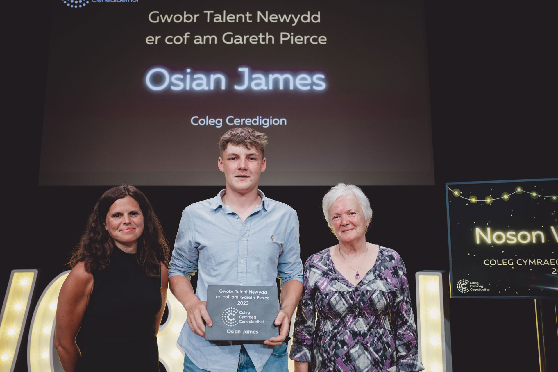 Osian James yn derbyn ei wobr gan aelod o deulu Gareth Pierce